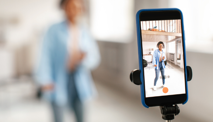 A person in front of their mobile phone camera